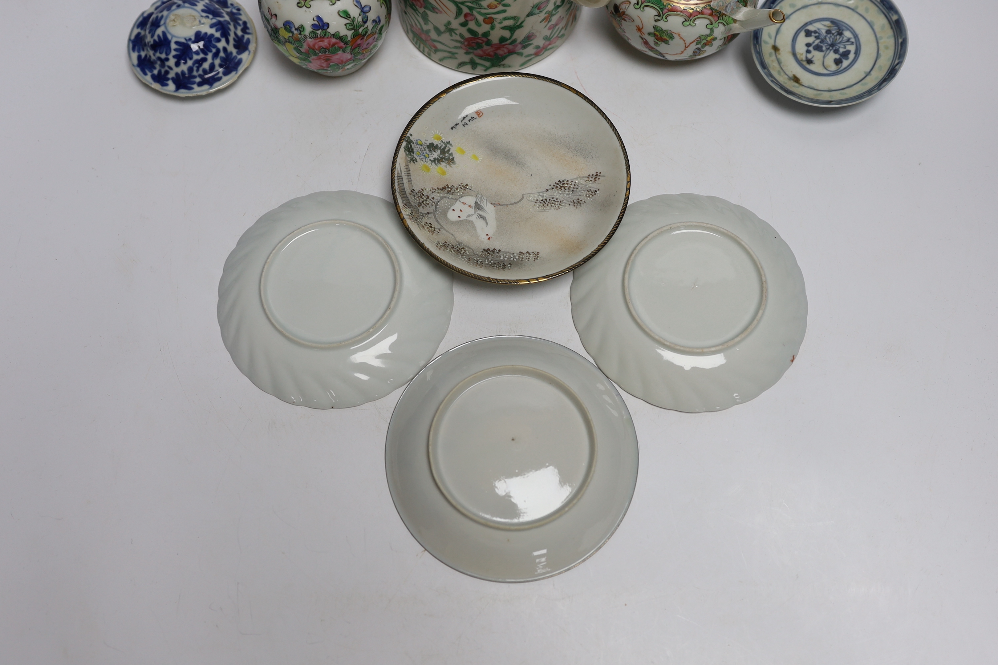 A collection of Chinese and Japanese ceramics including two famille rose teapots, a vase, four saucers, etc. (8)